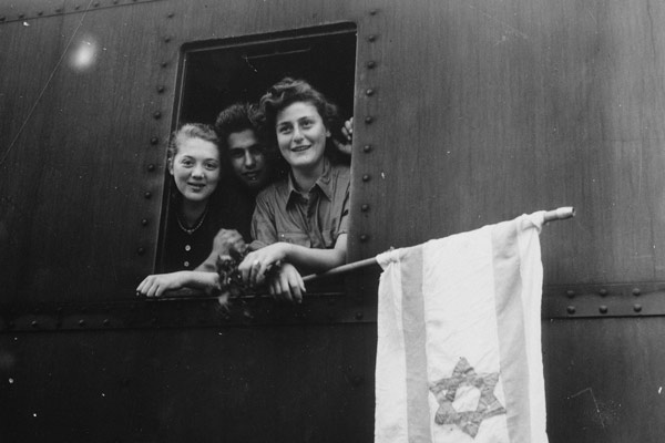 Children looking out the window of a train after being released from Buchenwald Concentration Camp